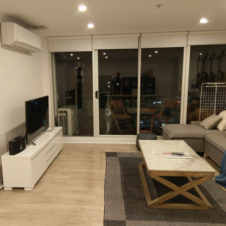 Professional cleaner cleaning a residential living room