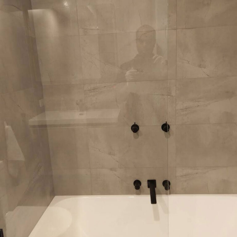 Professional cleaner deep cleaning bathroom surfaces and fixtures