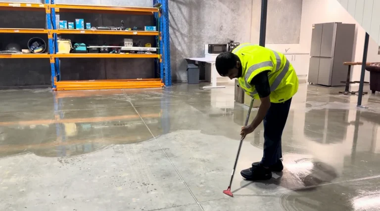 Professional cleaner performing detailed cleaning in a property